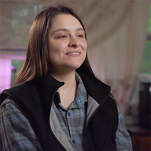 Portrait of Kalyn Morris wearing a black vest and plaid shirt
